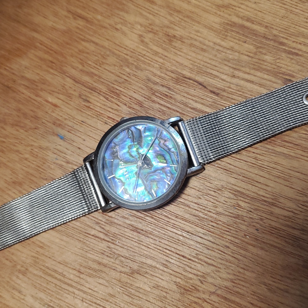 NEW Woman's Silver colored buckle watch with abalone colored face. DD
